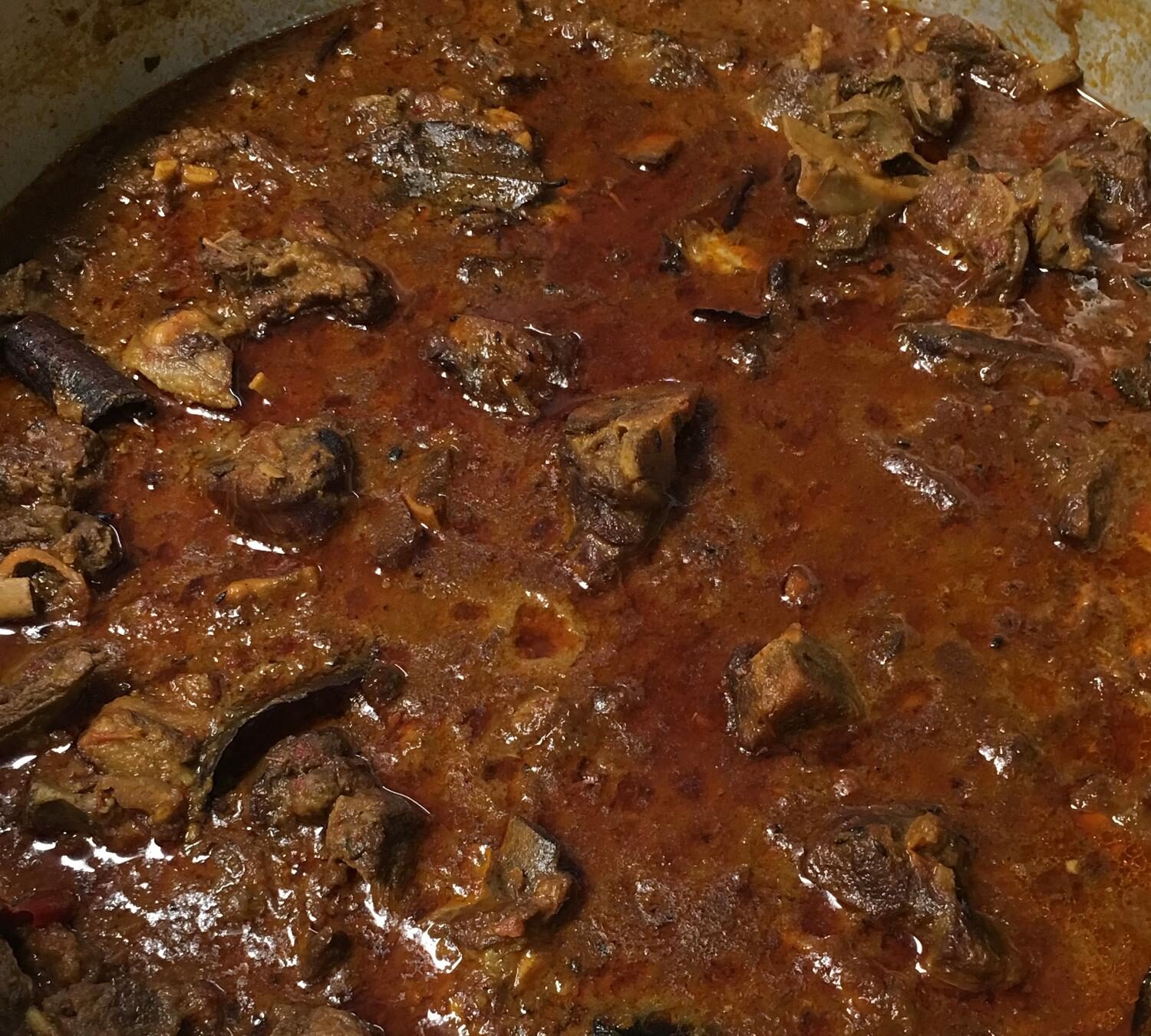 Slow-cooked gosht curry with bone-in lamb in rich spiced tomato gravy