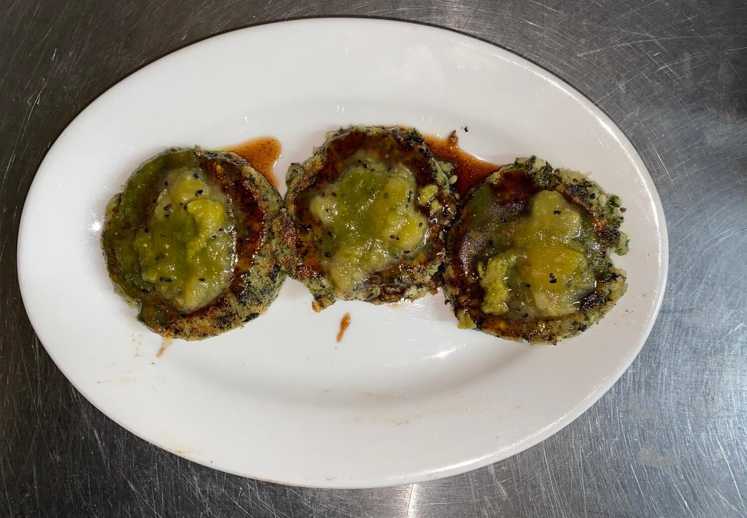Hara bhara kabab patties drizzled with mint and tamarind chutneys