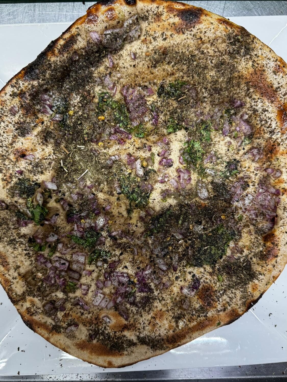 Tandoor-baked onion kulcha topped with cilantro and spices