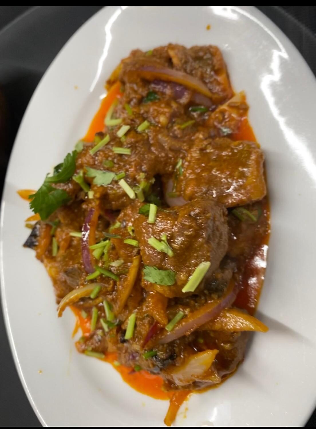 Slow-cooked lamb curry with onions, peppers and fresh herbs